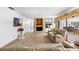 Inviting living room with stone fireplace, comfortable seating, and seamless access to the game room at 34 Misty Meadow Ln, Mulberry, FL 33860