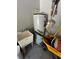 Utility area featuring a water heater, utility sink, and storage for tools and equipment at 34 Misty Meadow Ln, Mulberry, FL 33860