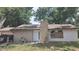 Exterior front view of a one-story home showcasing a brick chimney at 4202 Sunny View Dr, Lakeland, FL 33813