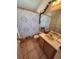 Well-lit bathroom with a shower-tub combo, vanity, and decorative plants at 4613 Eaglet Ln, Kissimmee, FL 34746