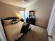 Cozy bedroom featuring a bed with decorative pillows, a nightstand, and a dresser at 4613 Eaglet Ln, Kissimmee, FL 34746