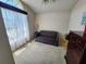 Bright bedroom with a large window, a comfortable couch, and a ceiling fan at 4613 Eaglet Ln, Kissimmee, FL 34746