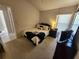 Comfortable bedroom featuring a bed with decorative pillows, a nightstand, and a TV at 4613 Eaglet Ln, Kissimmee, FL 34746