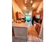 Galley style kitchen featuring wood cabinets, black appliances, tile floors, and an adjacent dining area with natural light at 4613 Eaglet Ln, Kissimmee, FL 34746