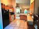 Open kitchen showing tile flooring, wood cabinets, and black appliances at 4613 Eaglet Ln, Kissimmee, FL 34746