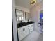 Contemporary bathroom with double sink vanity, sleek black faucets, and modern lighting at 4814 Myrtle View N Dr, Mulberry, FL 33860