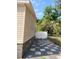 Side view of the house with a gate, showing the gravel driveway at 4814 Myrtle View N Dr, Mulberry, FL 33860