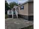 Charming home exterior featuring a white deck with white railings, blue shutters, and stone accent wall at 4814 Myrtle View N Dr, Mulberry, FL 33860