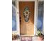 Inviting front door with decorative glass, surrounded by potted plants, adding charm and curb appeal at 4814 Myrtle View N Dr, Mulberry, FL 33860