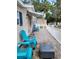 Inviting tiled front porch with blue chairs, great for enjoying the outdoors in comfort at 4814 Myrtle View N Dr, Mulberry, FL 33860