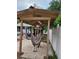 Covered patio featuring a relaxing hammock and outdoor seating, perfect for enjoying the backyard at 4814 Myrtle View N Dr, Mulberry, FL 33860
