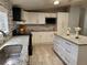Well-lit kitchen featuring granite counters, stainless sink, and sleek, white cabinetry with modern appliances at 4814 Myrtle View N Dr, Mulberry, FL 33860