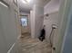 Functional laundry area with tile floor, shelving, and exterior access at 4814 Myrtle View N Dr, Mulberry, FL 33860