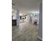 Open-concept space with tile floors leading to a modern kitchen with white cabinets and granite countertops at 4814 Myrtle View N Dr, Mulberry, FL 33860