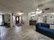 Inviting living room with wood-look flooring and comfortable blue sofa at 4814 Myrtle View N Dr, Mulberry, FL 33860
