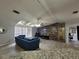 Bright living room with tile flooring, wood accent wall, and modern furniture for a comfortable living space at 4814 Myrtle View N Dr, Mulberry, FL 33860