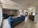 Cozy living room with a comfortable blue sofa and stylish wood-look accent wall at 4814 Myrtle View N Dr, Mulberry, FL 33860