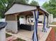 Relaxing patio with a cozy seating area, grill, and stylish curtains for privacy and shade at 4814 Myrtle View N Dr, Mulberry, FL 33860
