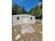 Exterior shot of a shed with a tan exterior and neutral colored double doors at 4814 Myrtle View N Dr, Mulberry, FL 33860