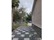 Side yard features a patterned stone walkway, leading to the driveway and the home's neutral vinyl siding at 4814 Myrtle View N Dr, Mulberry, FL 33860