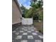 Side yard showcasing a decorative stone walkway and white vinyl fencing enclosing the backyard at 4814 Myrtle View N Dr, Mulberry, FL 33860