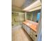 Well-lit bathroom features a shower and bath combination with a peach vanity at 511 Hawthorne Blvd, Leesburg, FL 34748