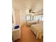 Bright bedroom featuring two twin beds, neutral walls, a ceiling fan and large windows at 511 Hawthorne Blvd, Leesburg, FL 34748
