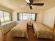 Bright bedroom featuring two twin beds, large windows, and neutral decor at 511 Hawthorne Blvd, Leesburg, FL 34748