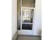 The entryway featuring a storm door and carpeted floor at 511 Hawthorne Blvd, Leesburg, FL 34748