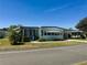 Inviting single-story home with a blue trimmed entry and well-kept front yard at 511 Hawthorne Blvd, Leesburg, FL 34748