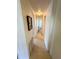 Tiled hallway with neutral colored walls leading to various rooms within the home at 511 Hawthorne Blvd, Leesburg, FL 34748