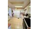 Bright kitchen features white appliances and tile flooring at 511 Hawthorne Blvd, Leesburg, FL 34748