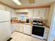 Well-lit kitchen with essential appliances and classic cabinets at 511 Hawthorne Blvd, Leesburg, FL 34748