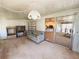Enclosed sunroom with a seating area and adjacent views of living and dining areas at 511 Hawthorne Blvd, Leesburg, FL 34748