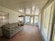 Comfortable sunroom with bright lighting and adjacent views of the main door and surrounding greenery at 511 Hawthorne Blvd, Leesburg, FL 34748