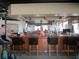 Well-lit bar area with bar stools, wooden bar, and mirrored wall, offering a social space at 7157 Hazeltine Cir, Lakeland, FL 33810