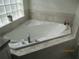 Bathroom featuring a large, luxurious soaking tub with crystal handle fixtures at 7157 Hazeltine Cir, Lakeland, FL 33810