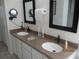 Bathroom vanity featuring double sinks, ample counter space, and framed mirrors at 7157 Hazeltine Cir, Lakeland, FL 33810