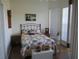 Bedroom with floral bedding and decor and a white wicker chest at 7157 Hazeltine Cir, Lakeland, FL 33810