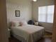 Bedroom features a large window and a comfortable sitting chair at 7157 Hazeltine Cir, Lakeland, FL 33810