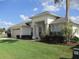 Charming single-story home with a well-manicured lawn, mature landscaping, and an attached two-car garage at 7157 Hazeltine Cir, Lakeland, FL 33810