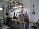 Organized garage space featuring a well-equipped workbench, hanging bicycles, and ample storage solutions at 7157 Hazeltine Cir, Lakeland, FL 33810