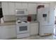 Efficient kitchen featuring white appliances, ample counter space, and updated cabinets at 7157 Hazeltine Cir, Lakeland, FL 33810