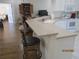 Bright kitchen featuring a breakfast bar, white cabinetry, and modern appliances at 7157 Hazeltine Cir, Lakeland, FL 33810