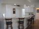 Bright kitchen with bar-style seating, neutral countertops, and ample lighting at 7157 Hazeltine Cir, Lakeland, FL 33810