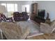 Spacious living room featuring hardwood floors, a patterned rug, and comfortable seating at 7157 Hazeltine Cir, Lakeland, FL 33810