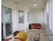 Enclosed patio with a hanging swing, bright yellow wicker chair, and sliding glass doors at 7157 Hazeltine Cir, Lakeland, FL 33810
