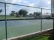 View of community tennis court with fence and blue and green playing surface at 7157 Hazeltine Cir, Lakeland, FL 33810