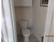 Toilet in a small water closet with white cabinets above at 7157 Hazeltine Cir, Lakeland, FL 33810