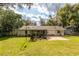 An expansive, grassy backyard with a patio offers plenty of space for outdoor enjoyment at 727 Se 12Th St, Ocala, FL 34471